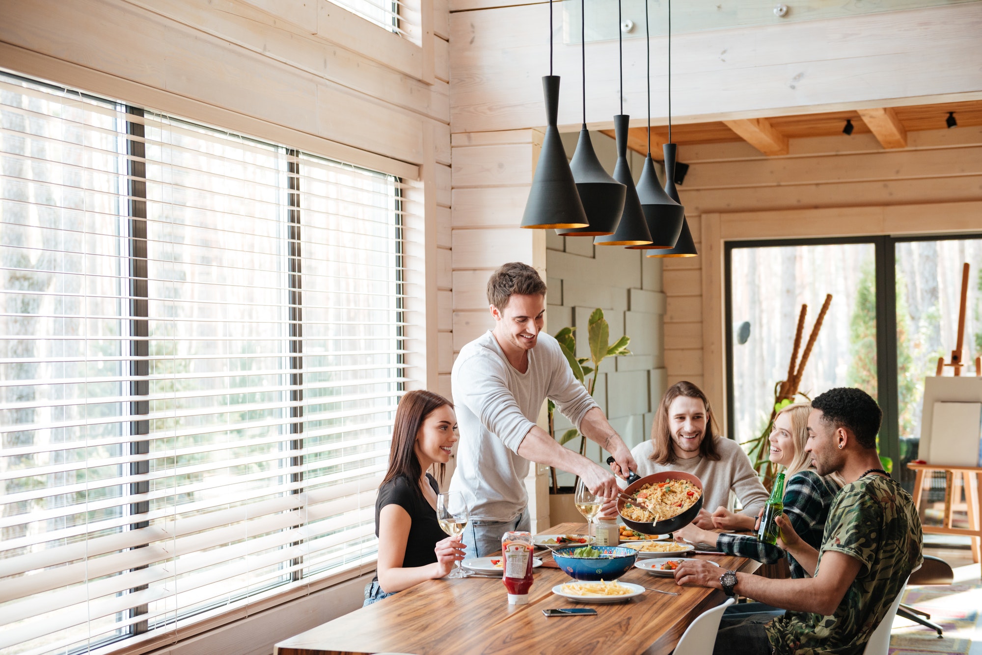 cheerful-young-people-eating-pasta-and-talking-on-the-kitchen.jpg